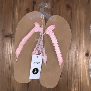 Big girls, pink sparkle flip flops
